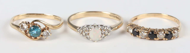 A 9ct gold, opal and diamond ring, claw set with the oval opal between