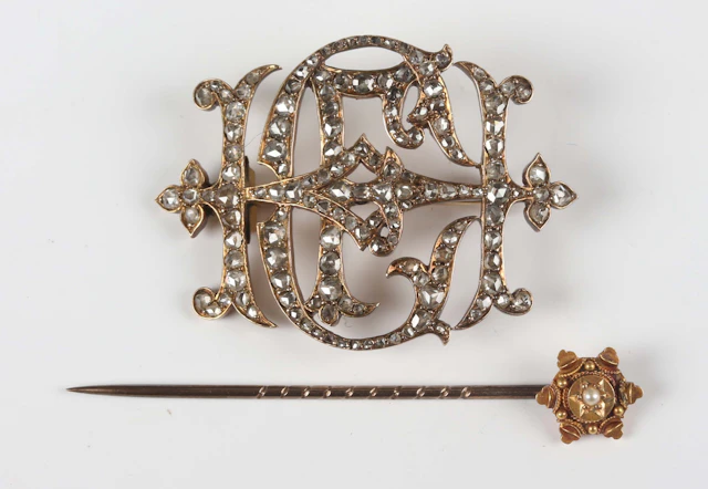 A gold backed and rose cut diamond monogram brooch, unmarked, weight
