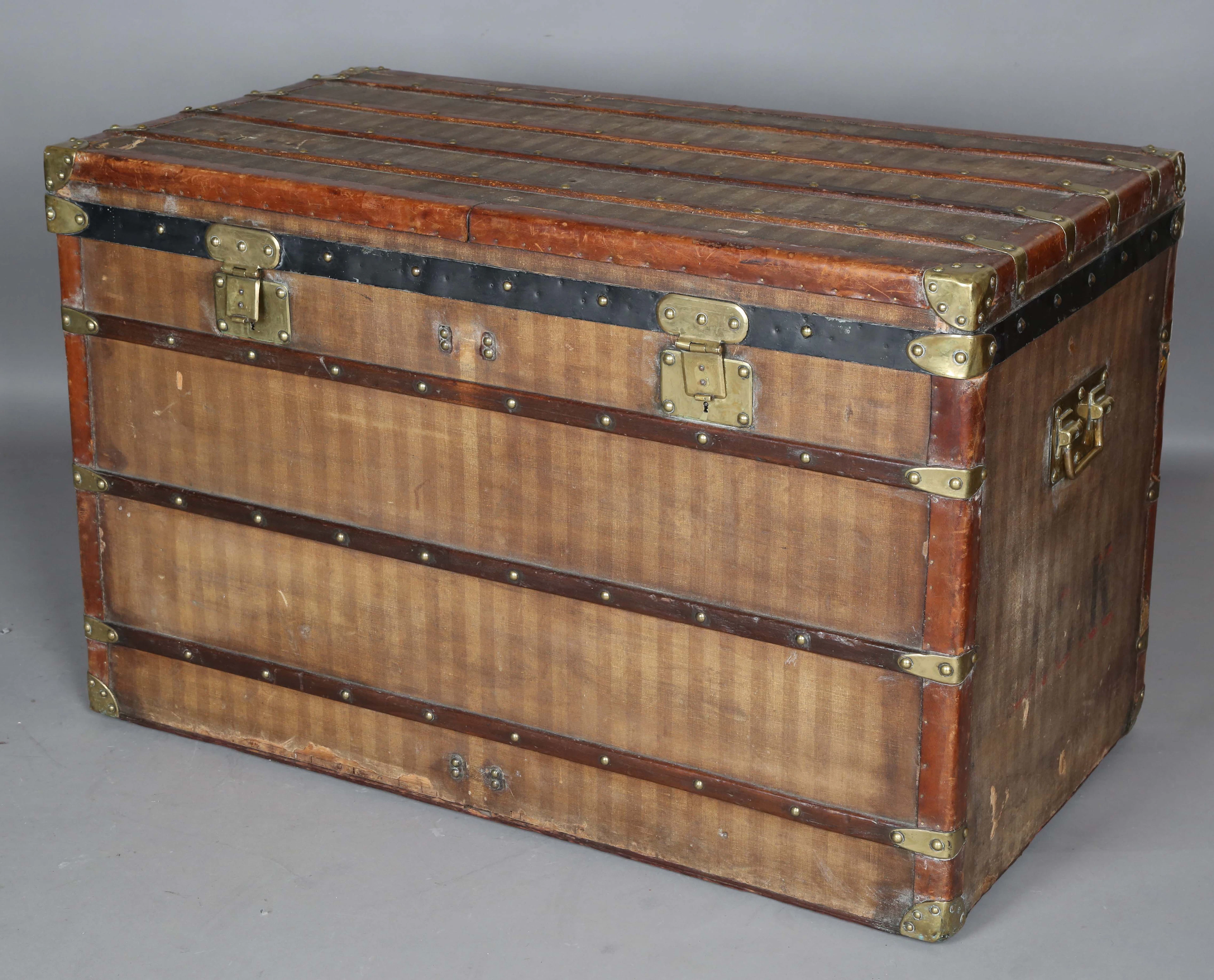 A large early 20th century Louis Vuitton travelling trunk with overall