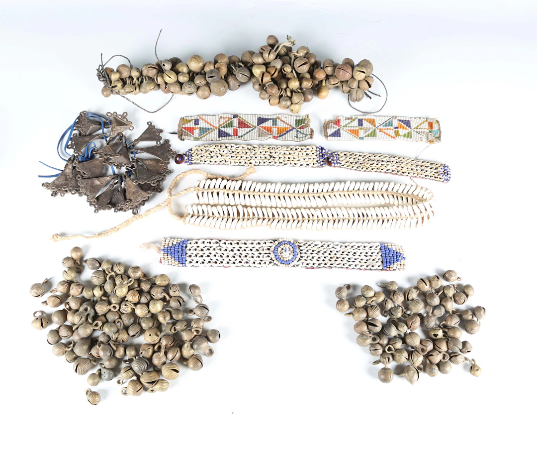 A group of African beadwork and shell appliqué bracelets and collars