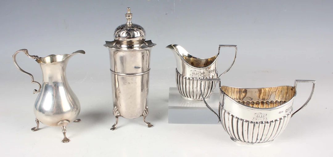 A late Victorian silver half-reeded two-handled sugar bowl and matching