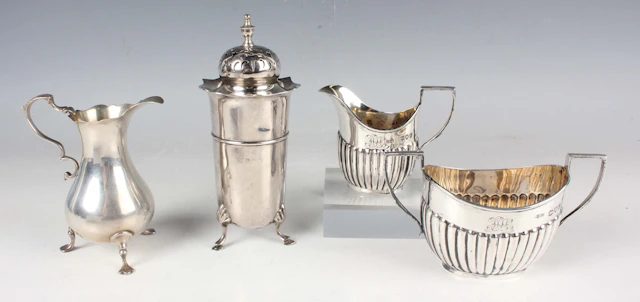 A late Victorian silver half-reeded two-handled sugar bowl and matching
