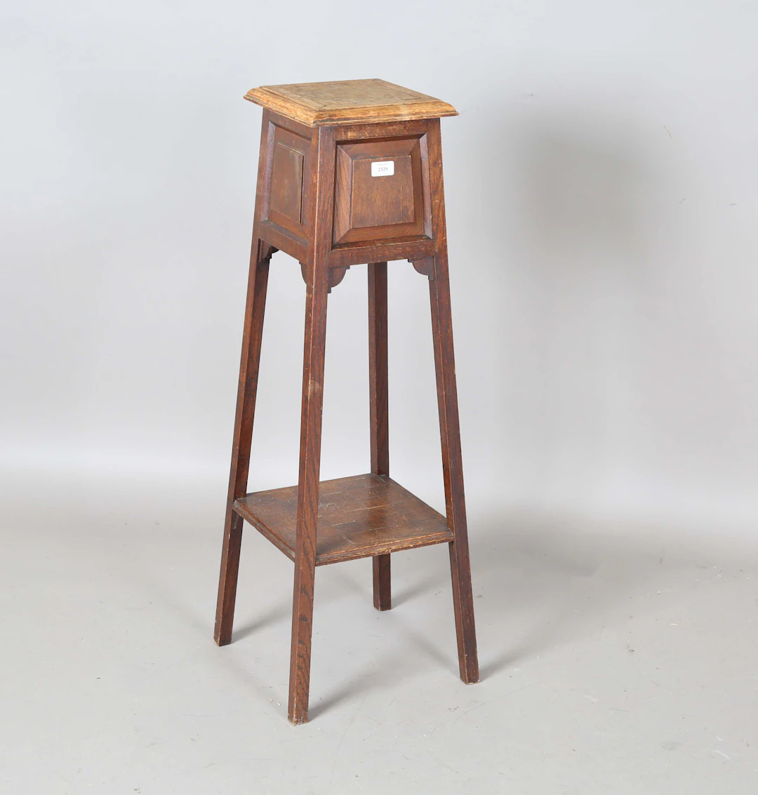 An early 20th century Arts and Crafts oak two-tier jardinière stand
