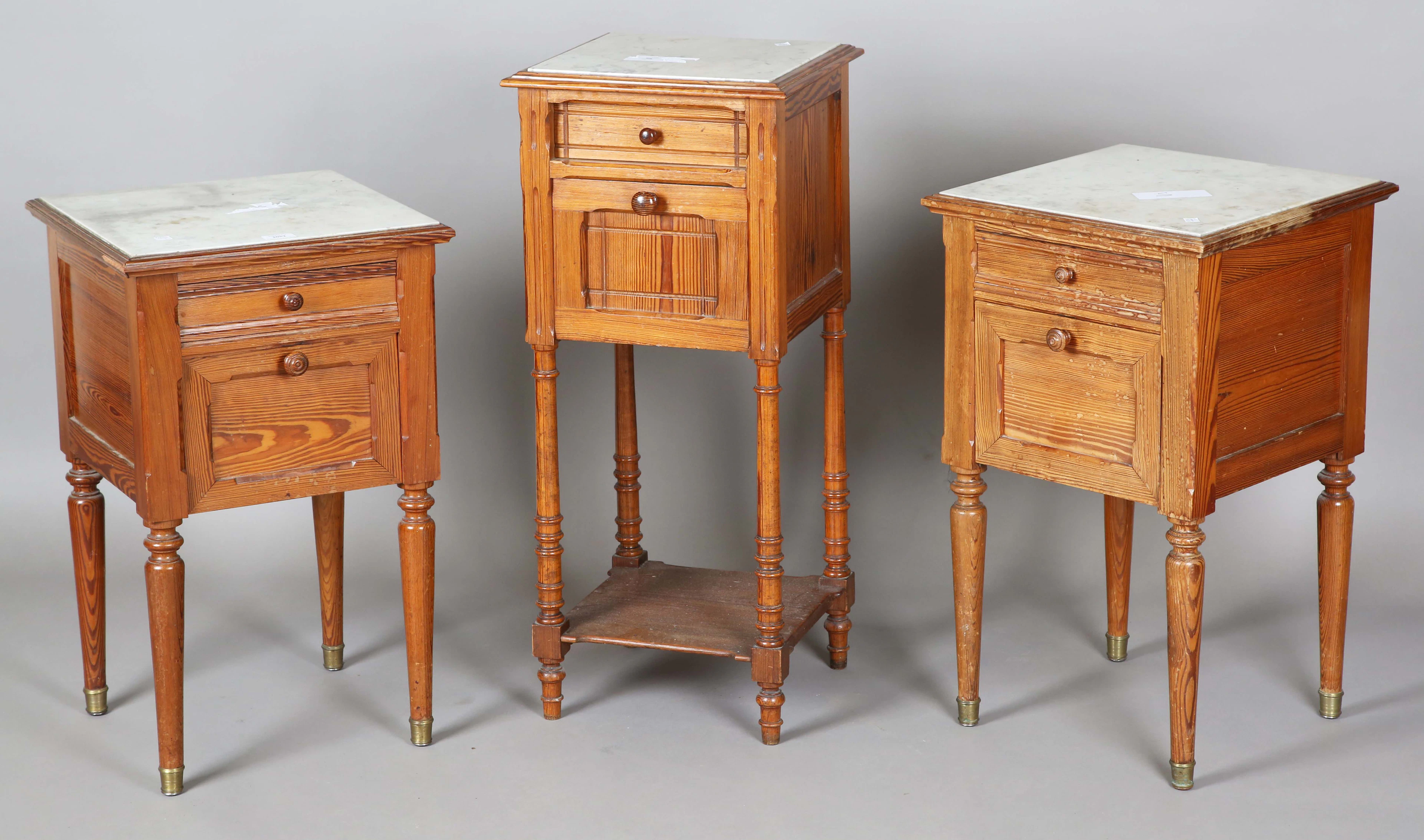A near pair of early 20th century pitch pine marble-topped bedside