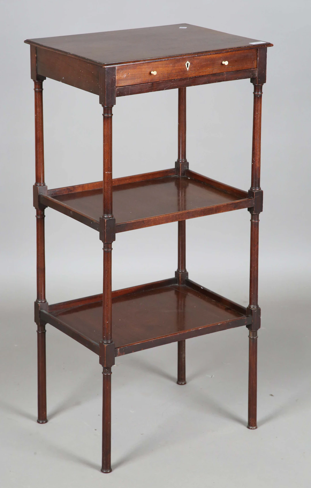 A George III mahogany three-tier whatnot, fitted with a single drawer
