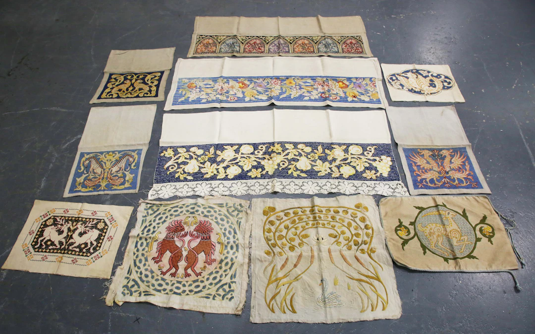 A group of five early 20th century Arts and Crafts embroidered linen