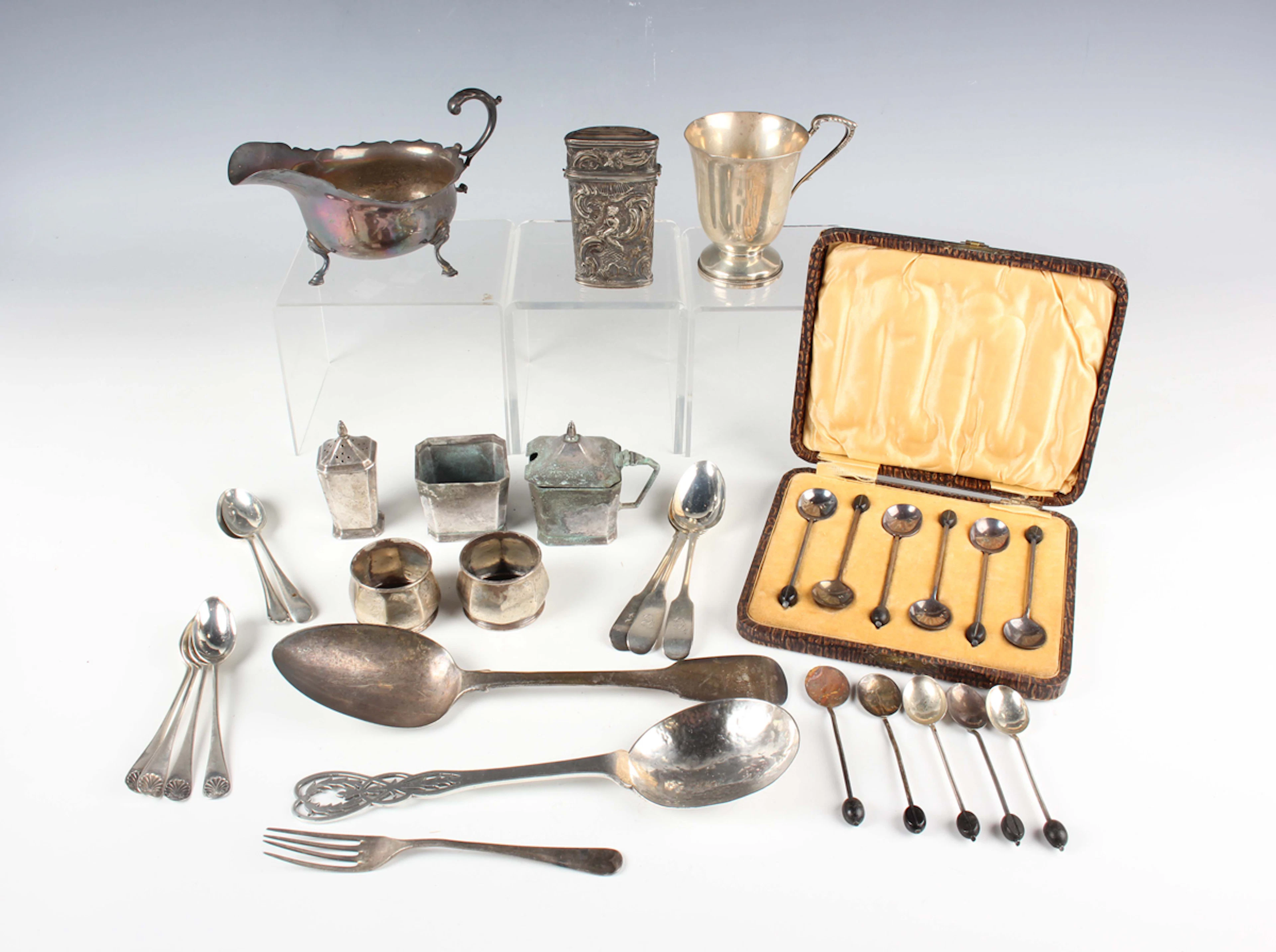 A George V silver serving spoon with hammered bowl and pierced bellflower