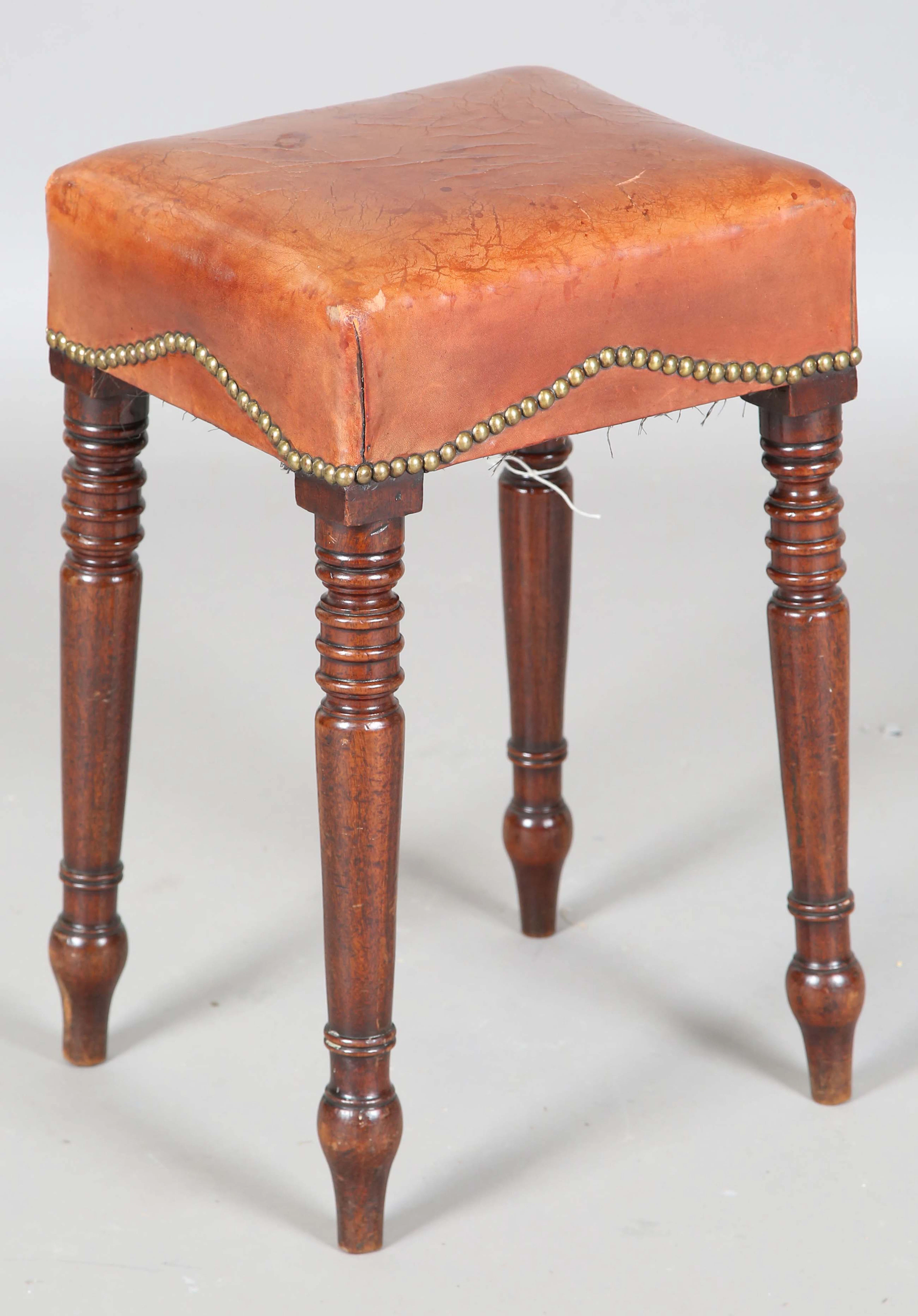 A Regency mahogany stool with a brass studded tan leather seat, on