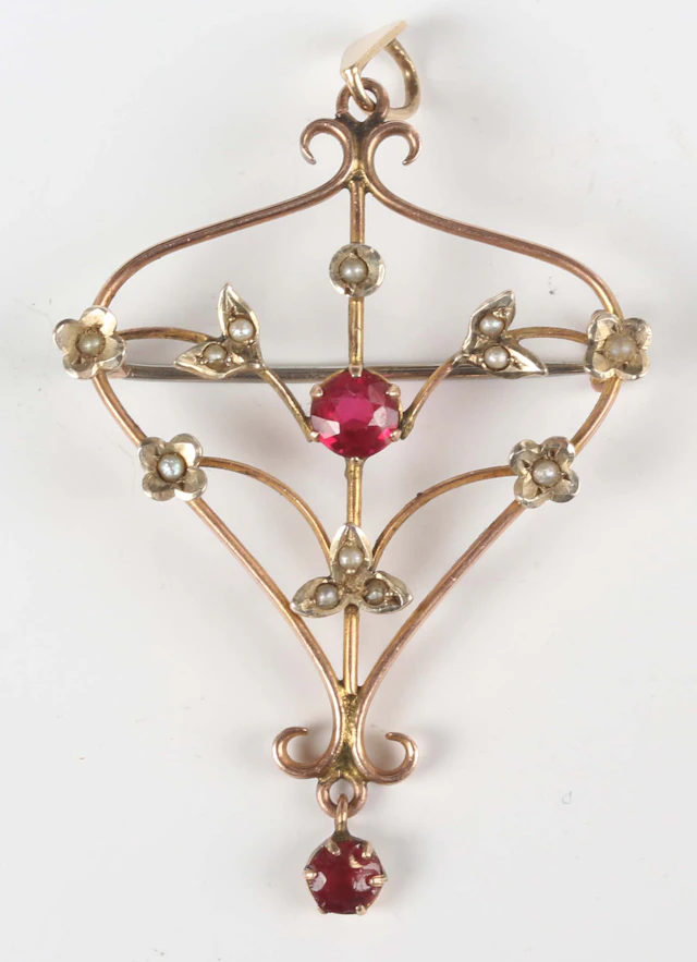 An Edwardian gold, seed pearl and red paste set pendant brooch in