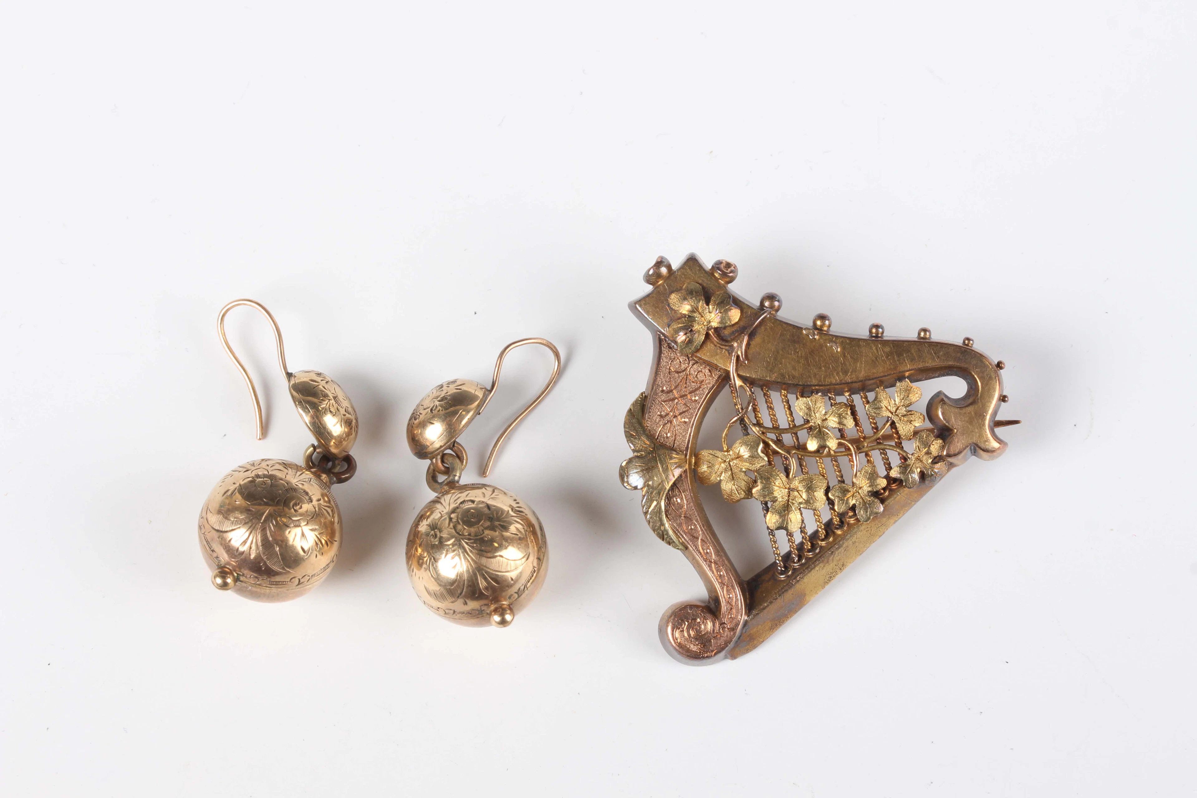 A Victorian gold brooch, designed as a harp, decorated with applied