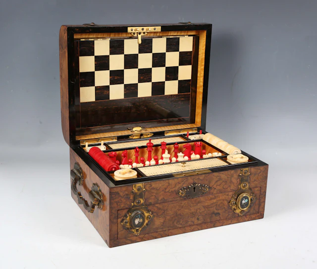 A mid-Victorian burr walnut and gilt brass mounted games compendium