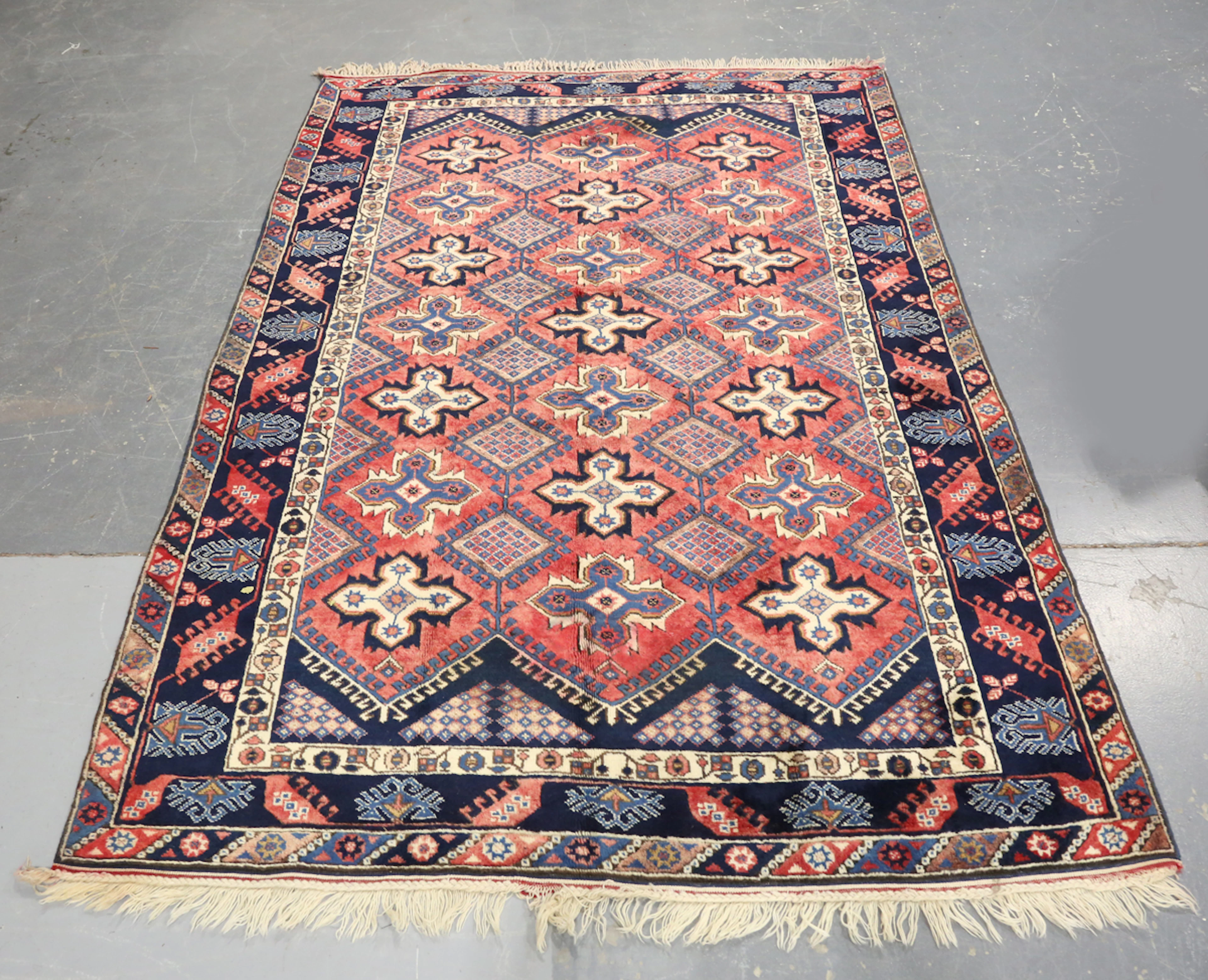 A Turkish carpet, late 20th century, the pink field with overall hooked