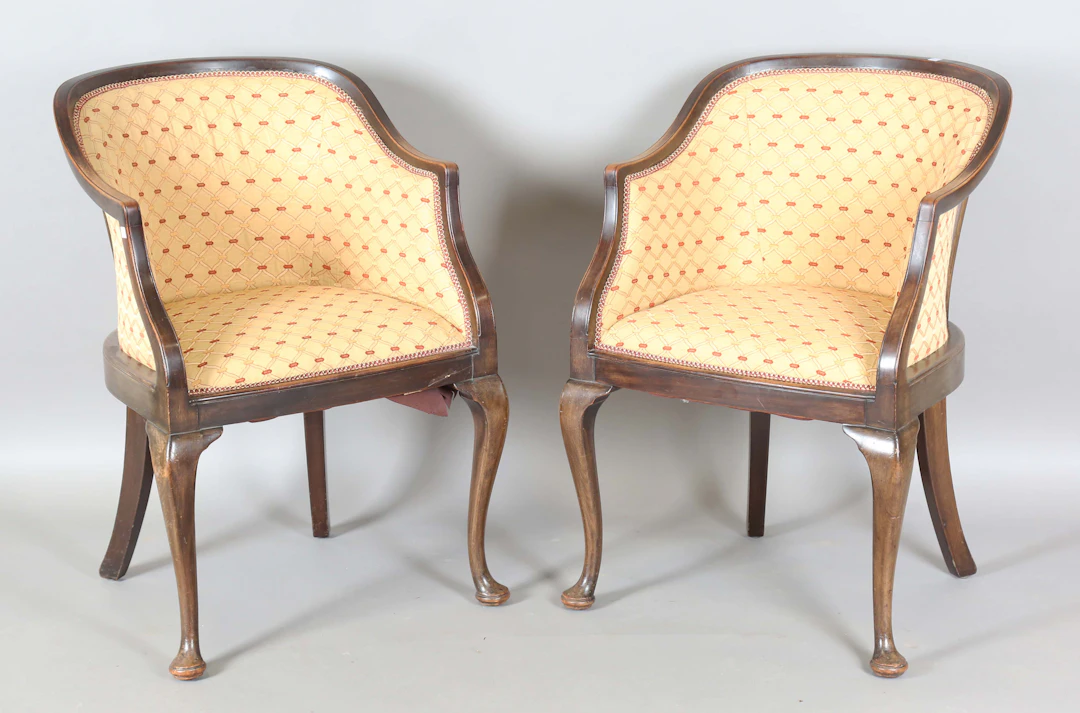 A pair of Edwardian tub back showframe armchairs, on cabriole legs