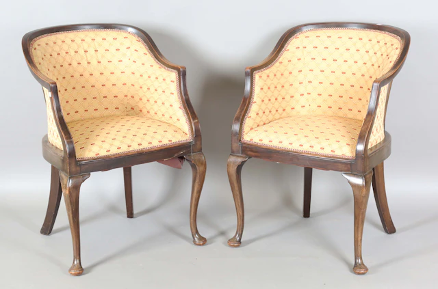 A pair of Edwardian tub back showframe armchairs, on cabriole legs
