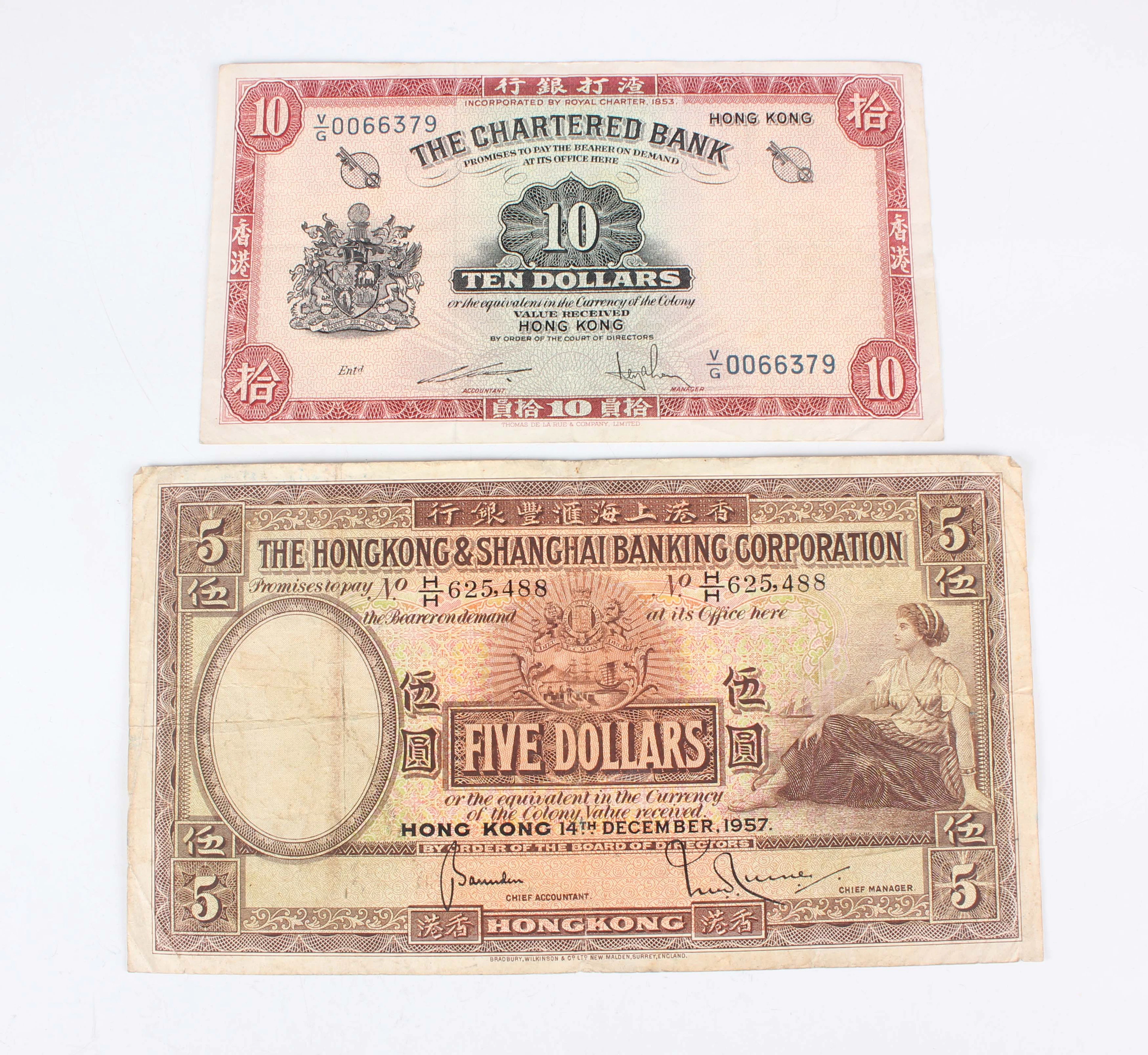 A collection of Chinese banknotes, including a Chartered Bank ten