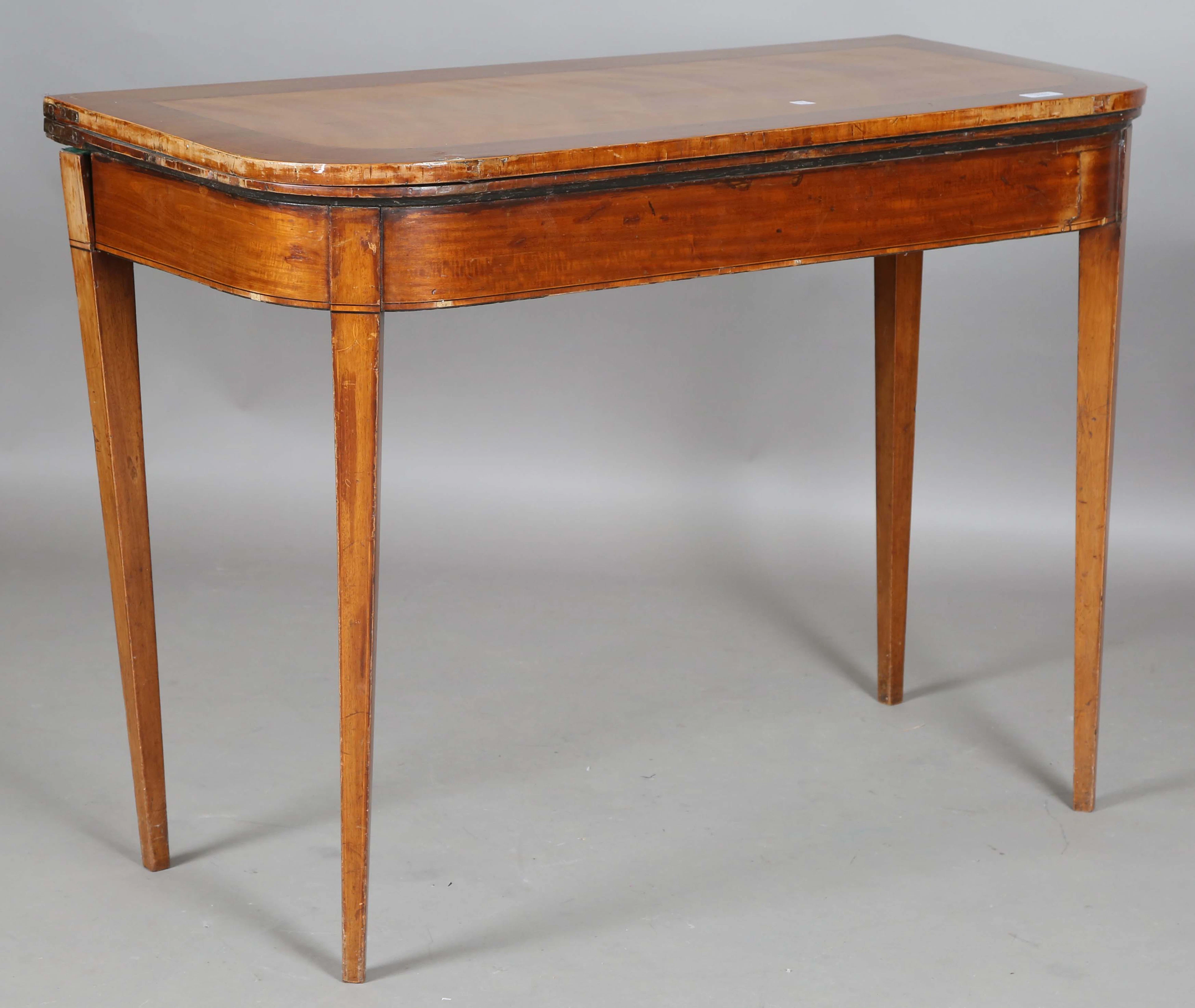 A George III satin birch fold-over card table, on square tapering