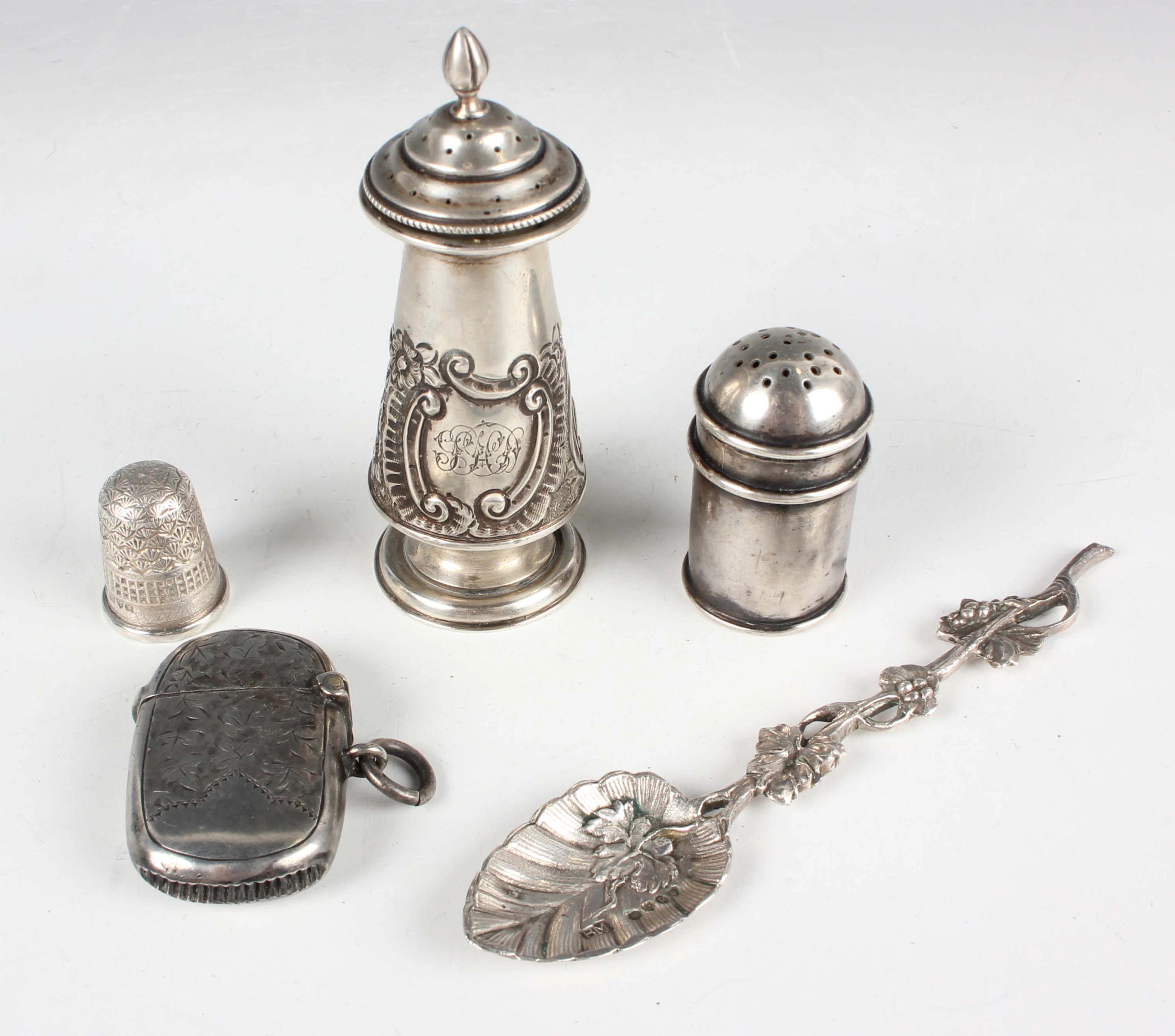 A late Victorian silver pepper caster of conical form with embossed