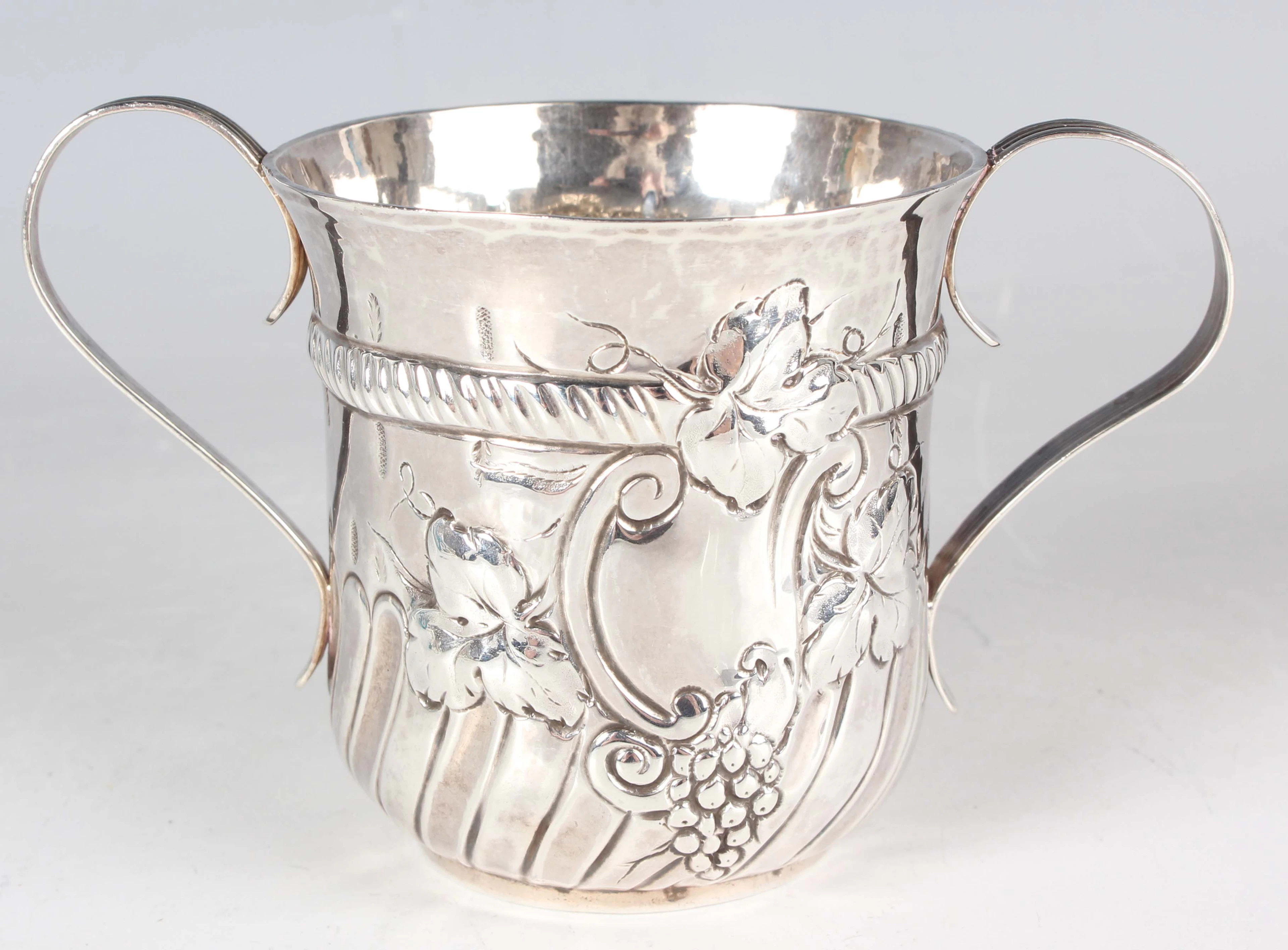 A George III silver porringer, the slightly tapered half-spiral-reeded