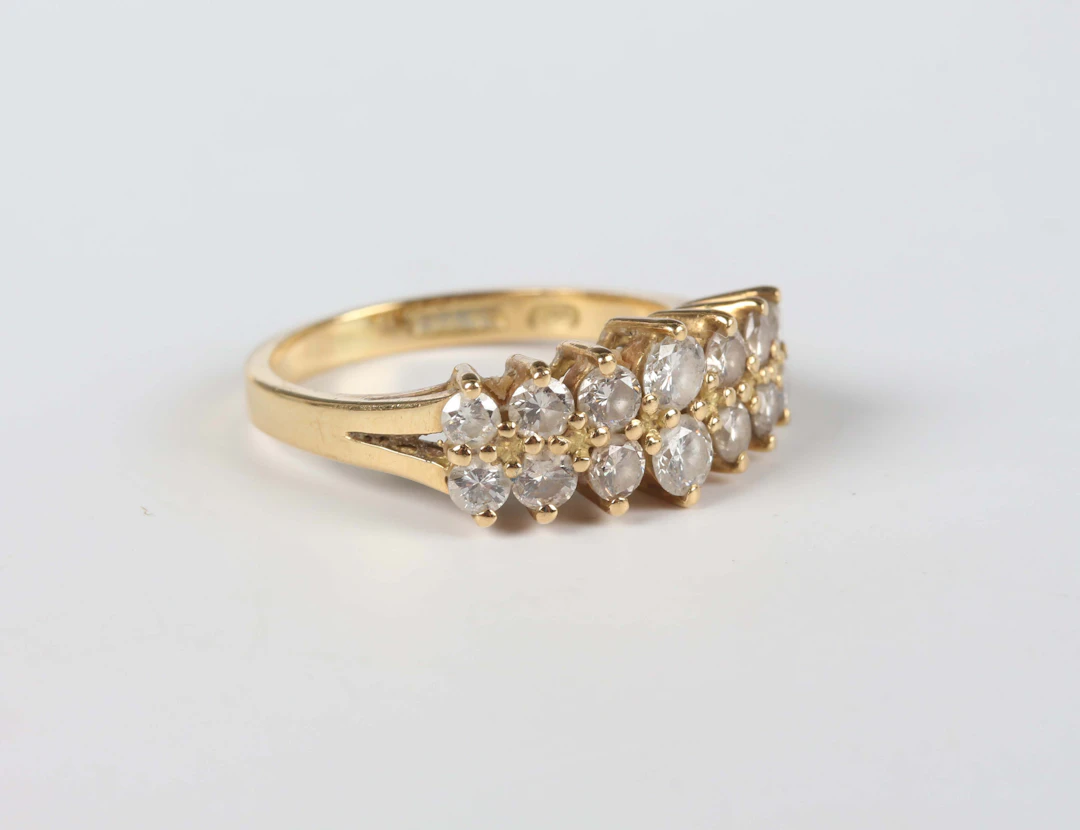An 18ct gold and diamond ring, mounted with two rows of graduated