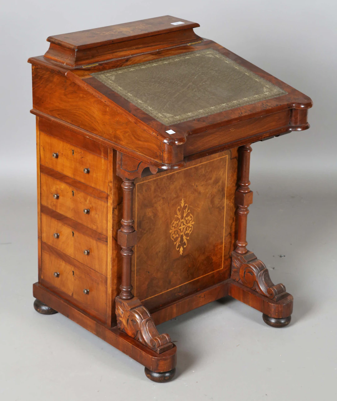 A 20th century Victorian style walnut Davenport with foliate inlay
