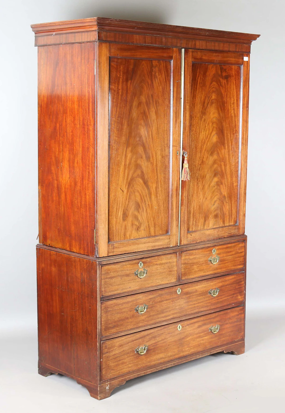 A George III mahogany linen press, the two panelled doors above two
