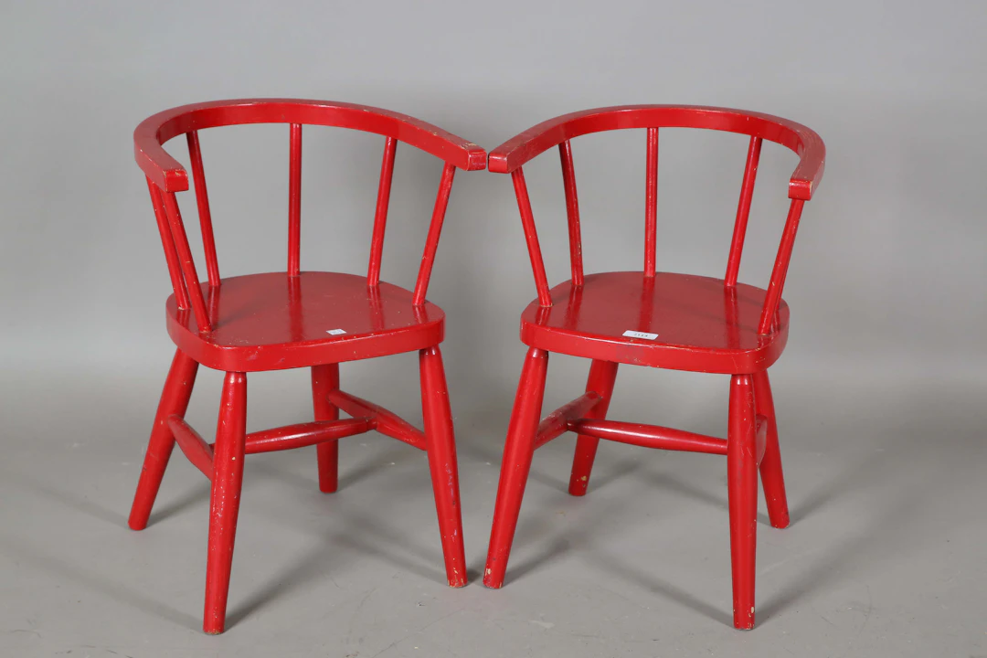 A pair of 20th century red painted tub back Windsor children's chairs