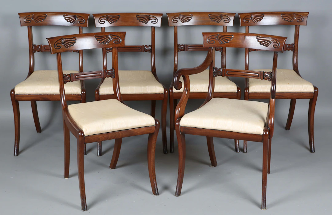 A set of six George IV mahogany bar back dining chairs, carved with