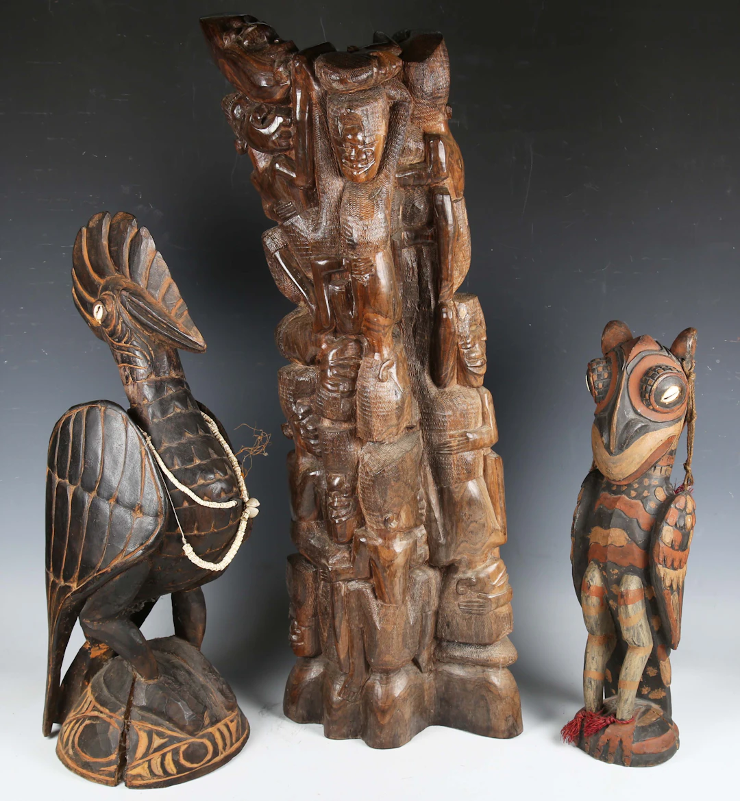 A Papua New Guinea carved wooden model of an exotic bird with inset