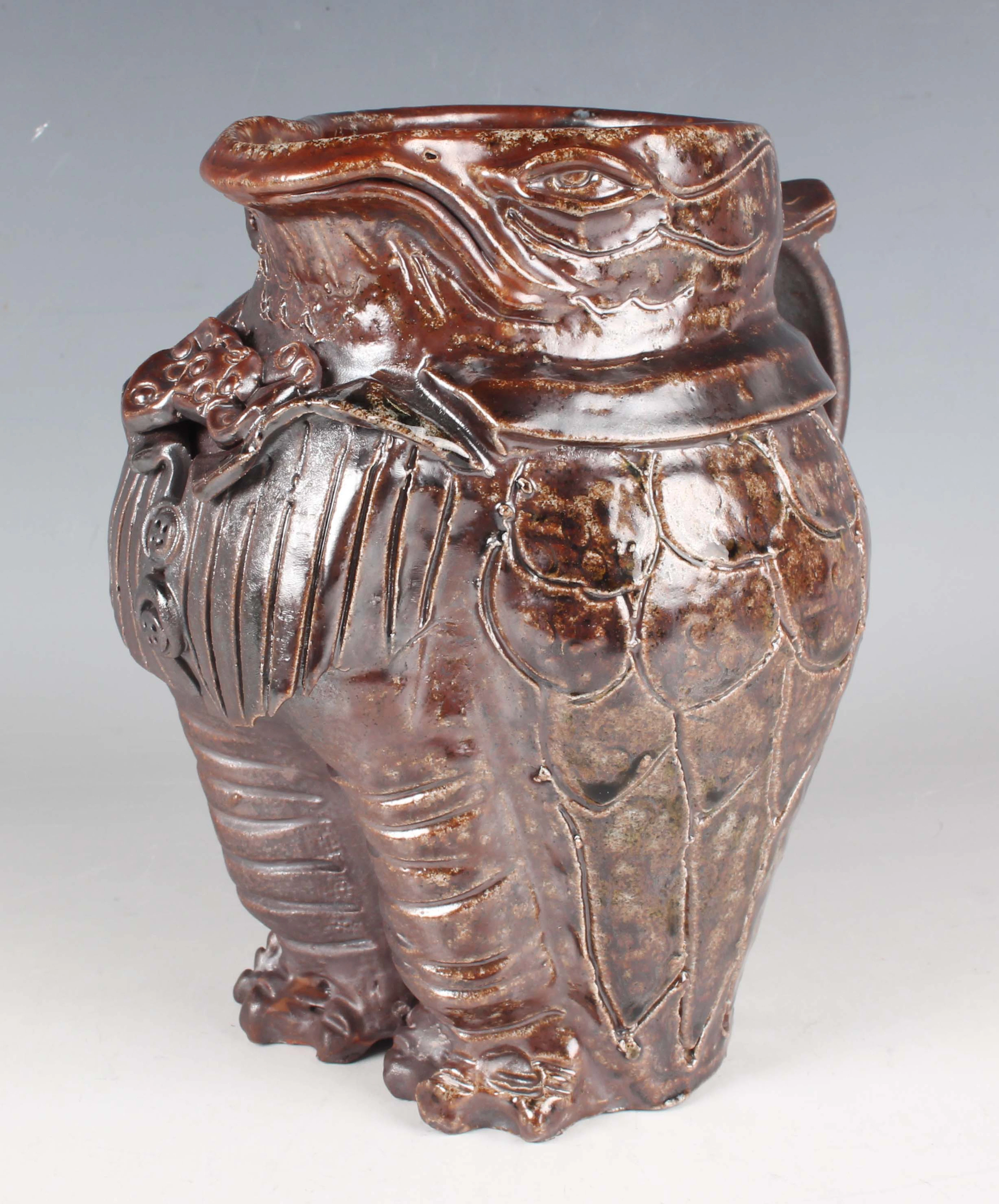 A stoneware studio pottery jug in the form of a grotesque bird, probably