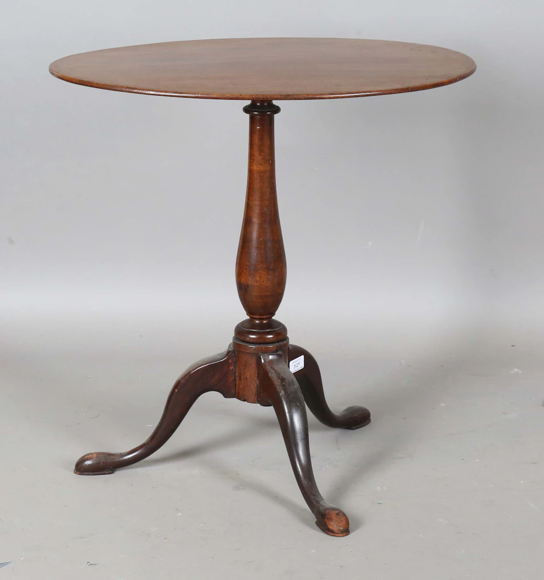 A 19th century mahogany oval wine table, raised on a turned stem and