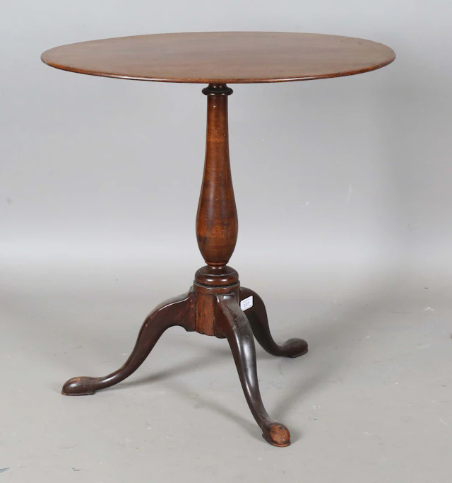 A 19th century mahogany oval wine table, raised on a turned stem and
