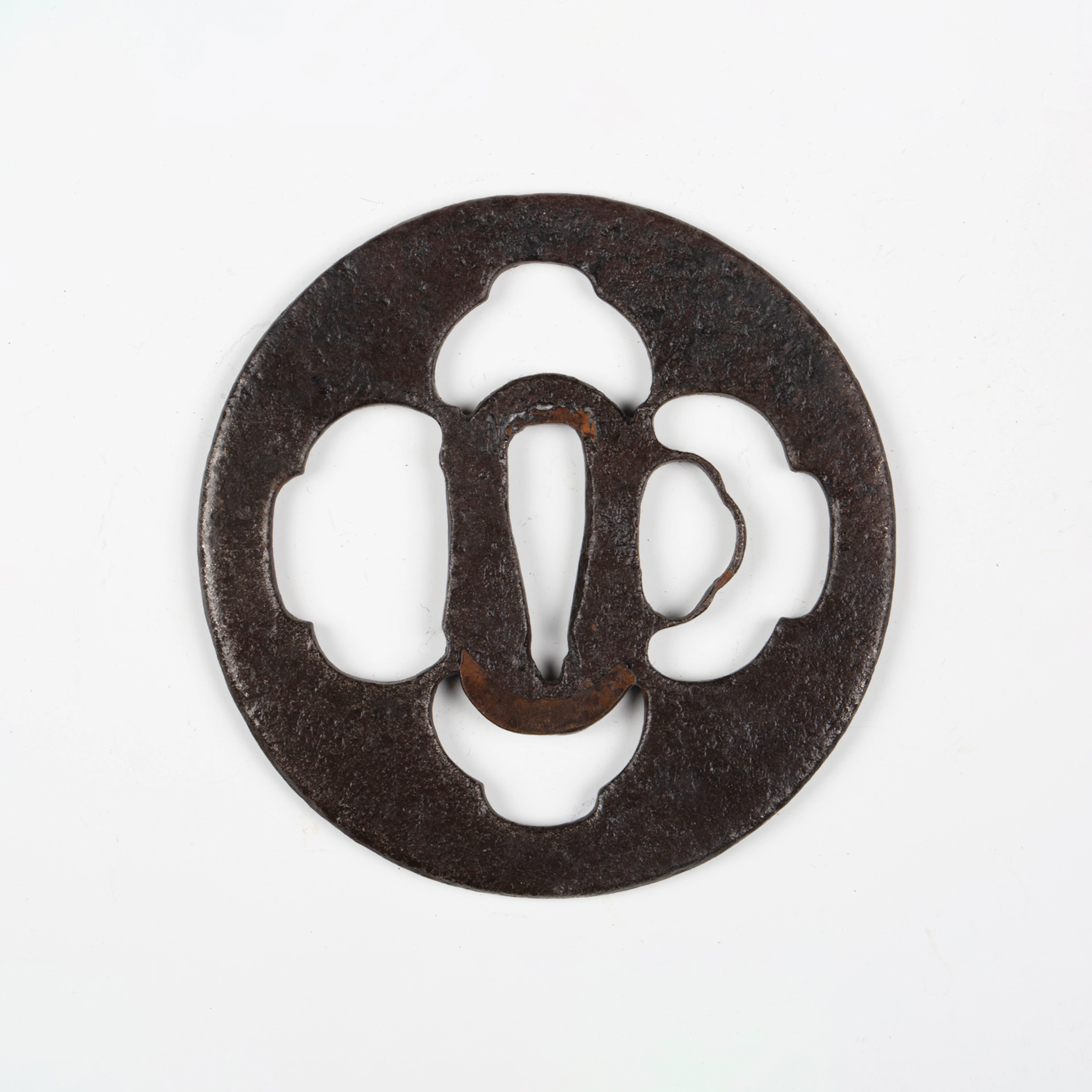 A Japanese circular steel and pierced-decorated iron sukashi tsuba
