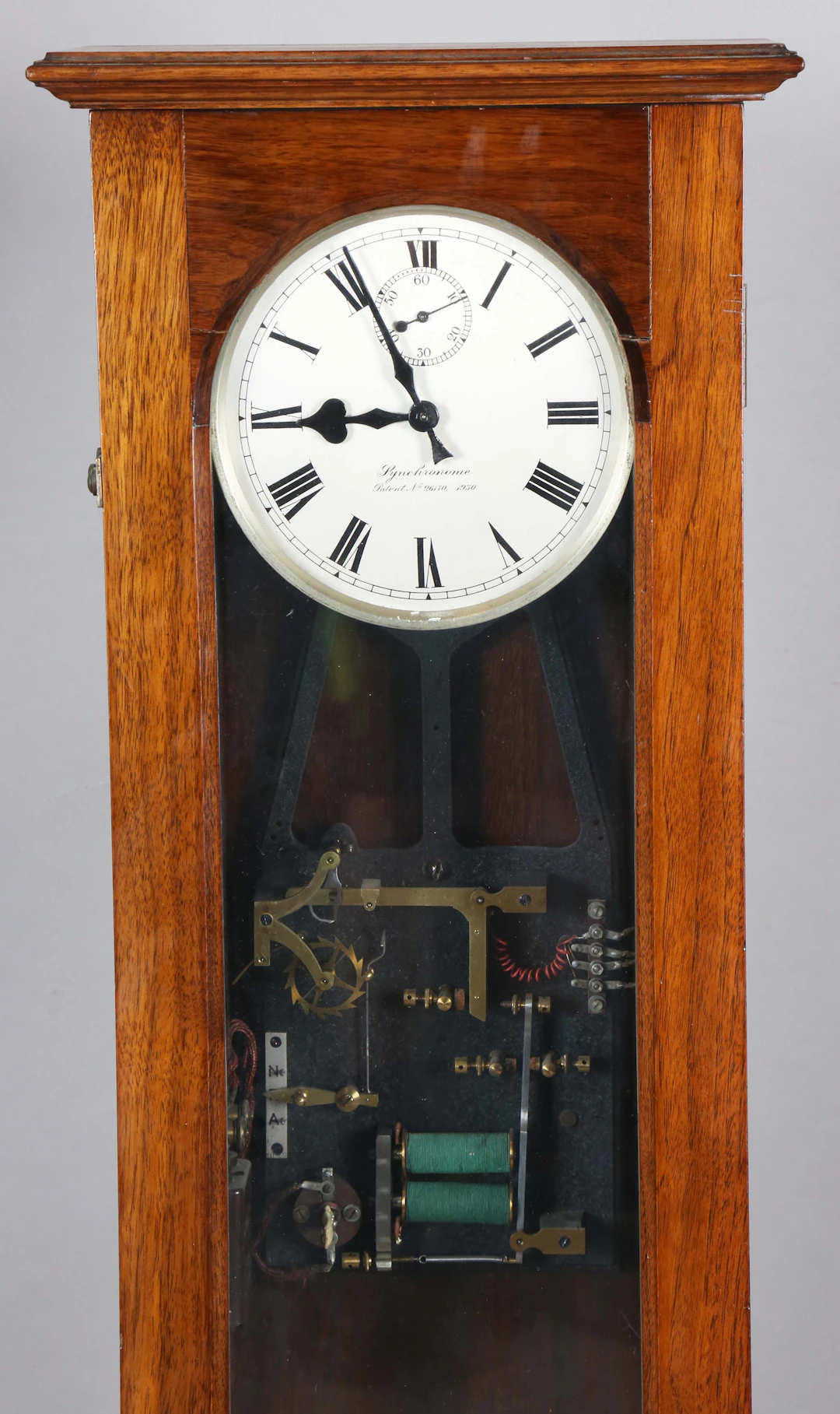A Synchronome electric master clock, the 7-inch circular silvered