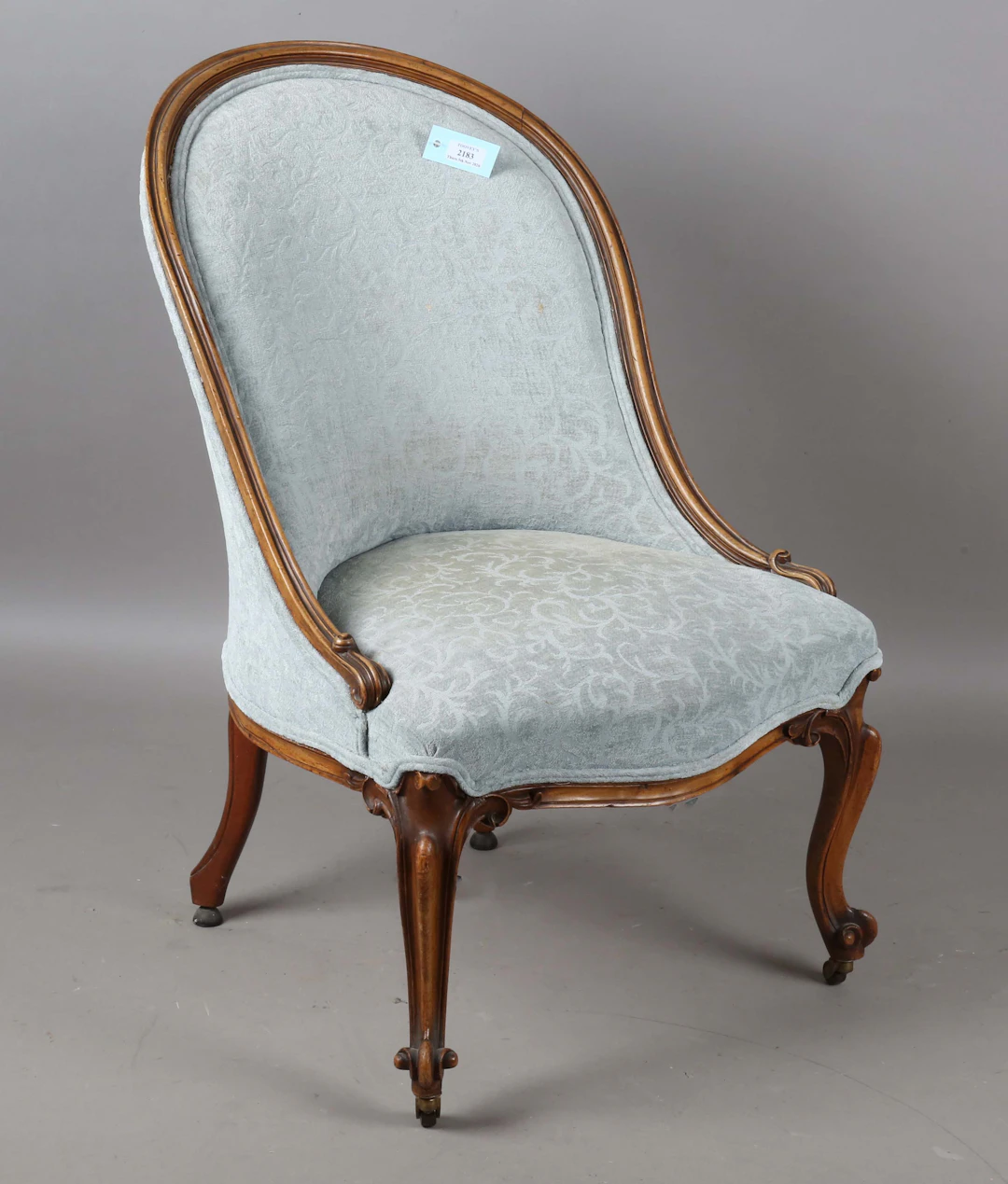 A mid-Victorian walnut showframe salon chair, on carved cabriole legs