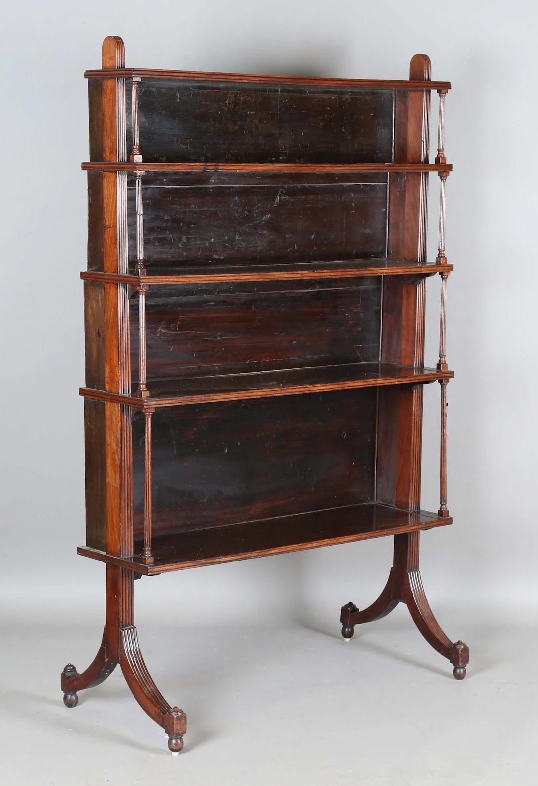A 19th century mahogany four-tier open waterfall bookcase, probably