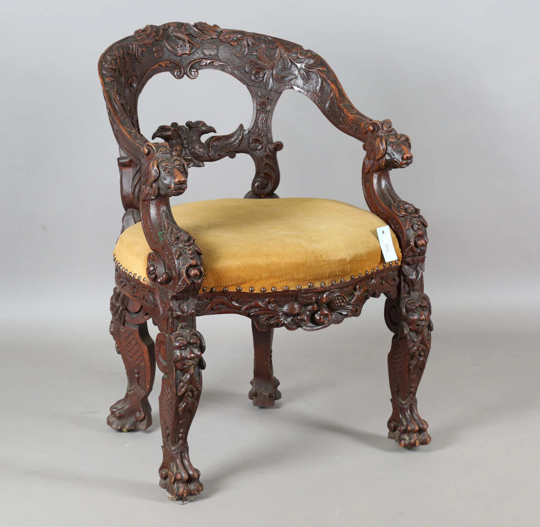 A late 19th century carved oak tub back chair, the frame carved with