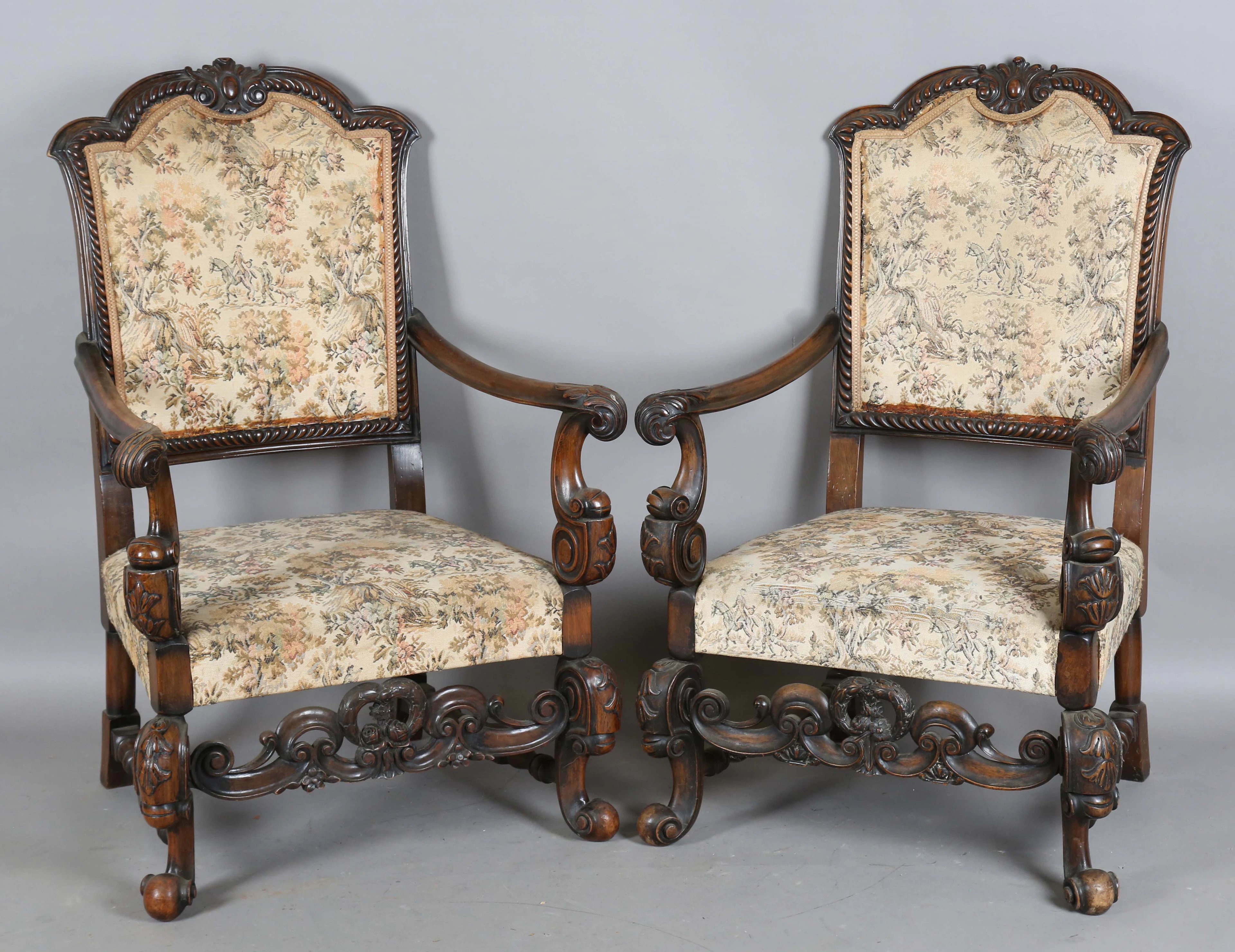 A pair of early 20th century Carolean Revival walnut framed armchairs
