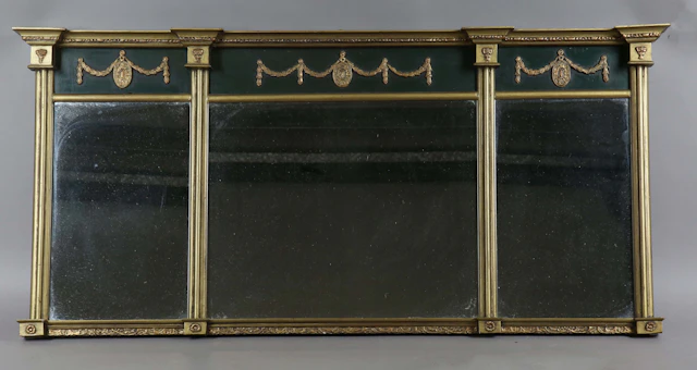 An early 20th century Regency style gilt and black painted overmantel