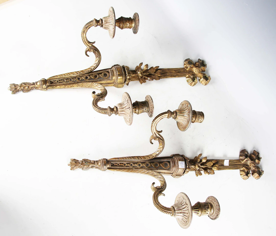 A pair of late 19th century gilt brass twin-light wall sconces of
