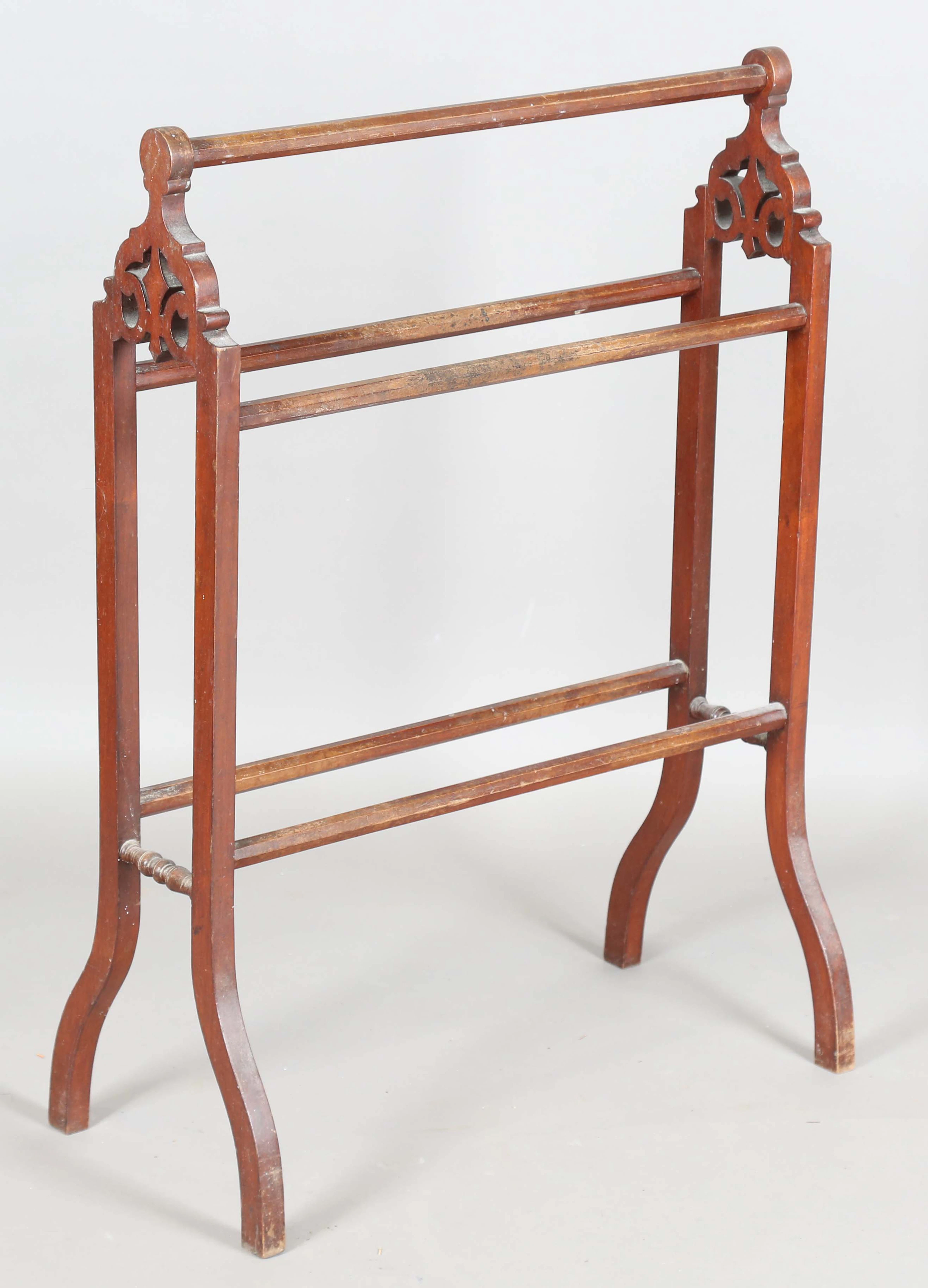 A late Victorian walnut framed towel rail, height 87cm, width 63cm.