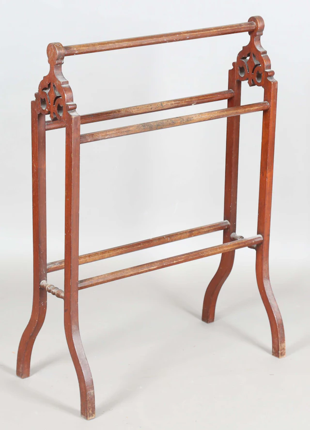 A late Victorian walnut framed towel rail, height 87cm, width 63cm.