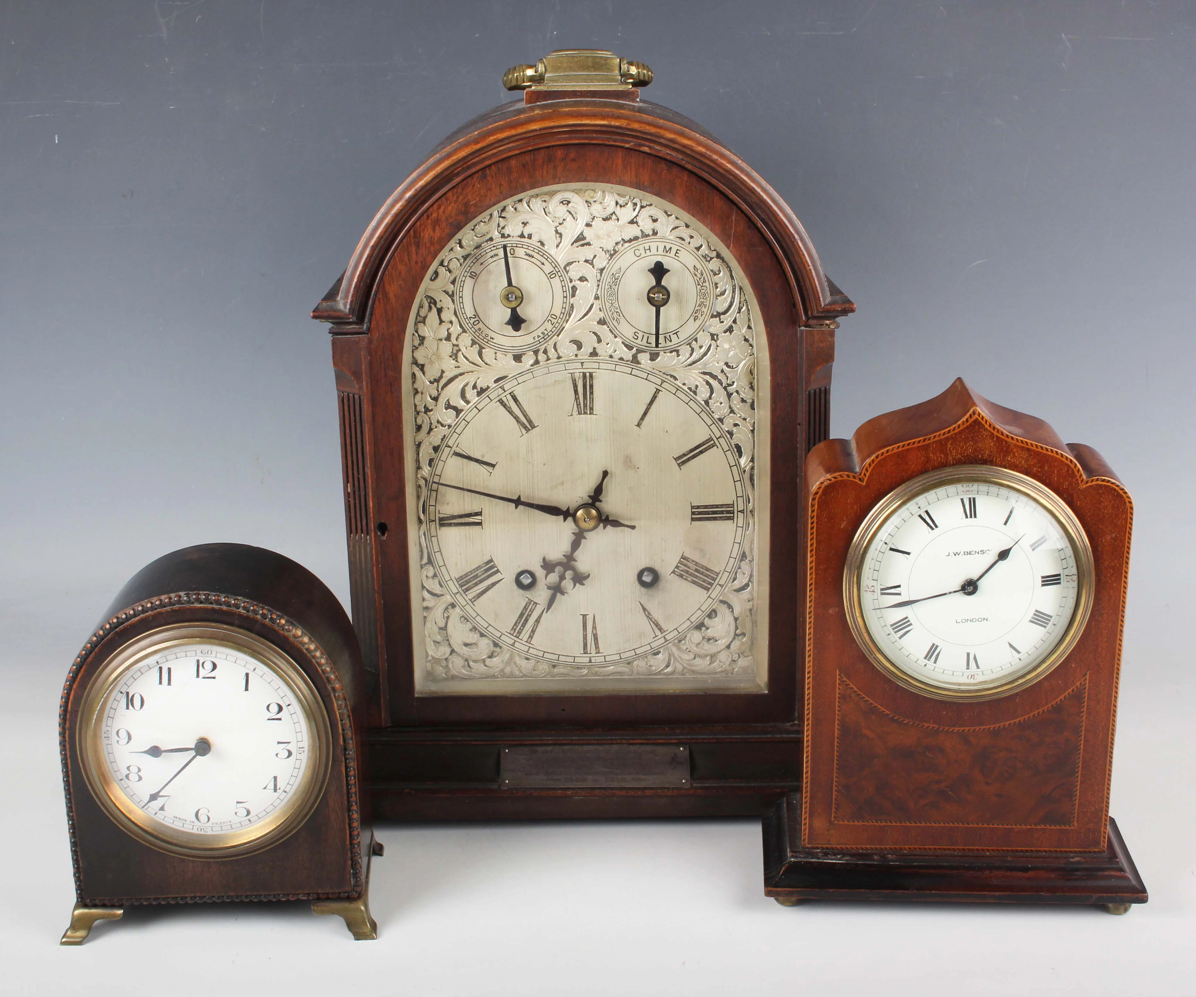 An early 20th century oak cased mantel clock with eight day movement