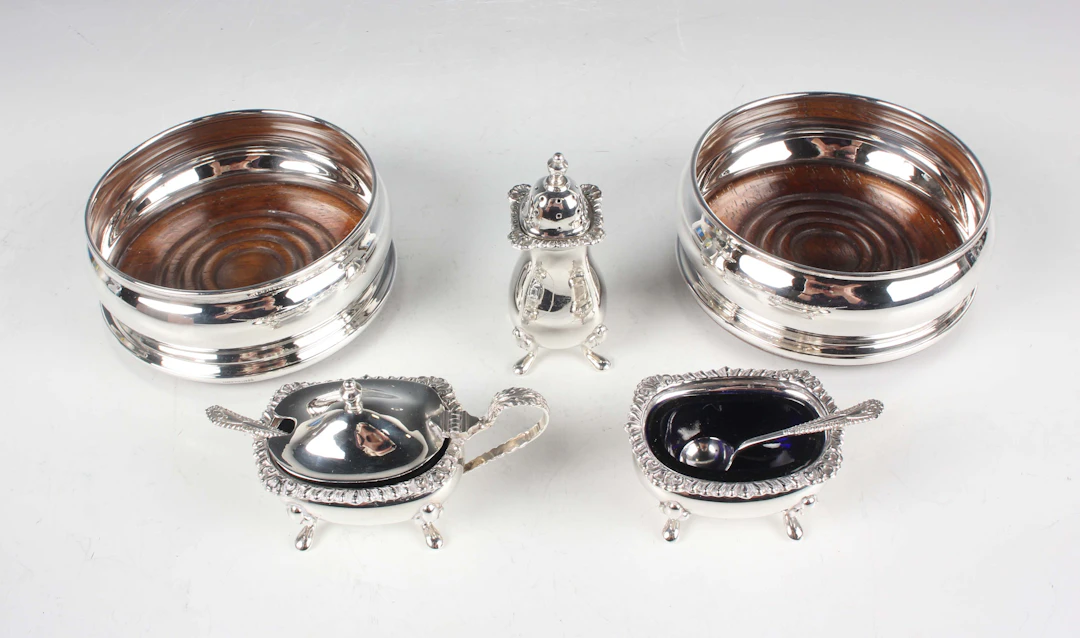An Elizabeth II silver three-piece condiment set of cushion form with