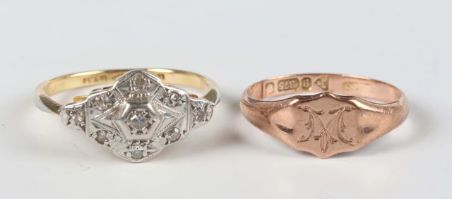 A gold, platinum and diamond cluster ring in a shaped lozenge design