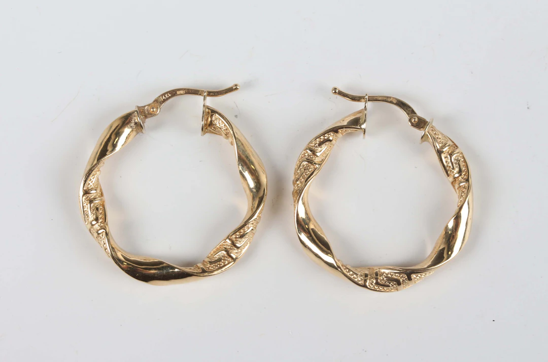 A pair of Italian gold hoop shaped earrings of twist design, detailed