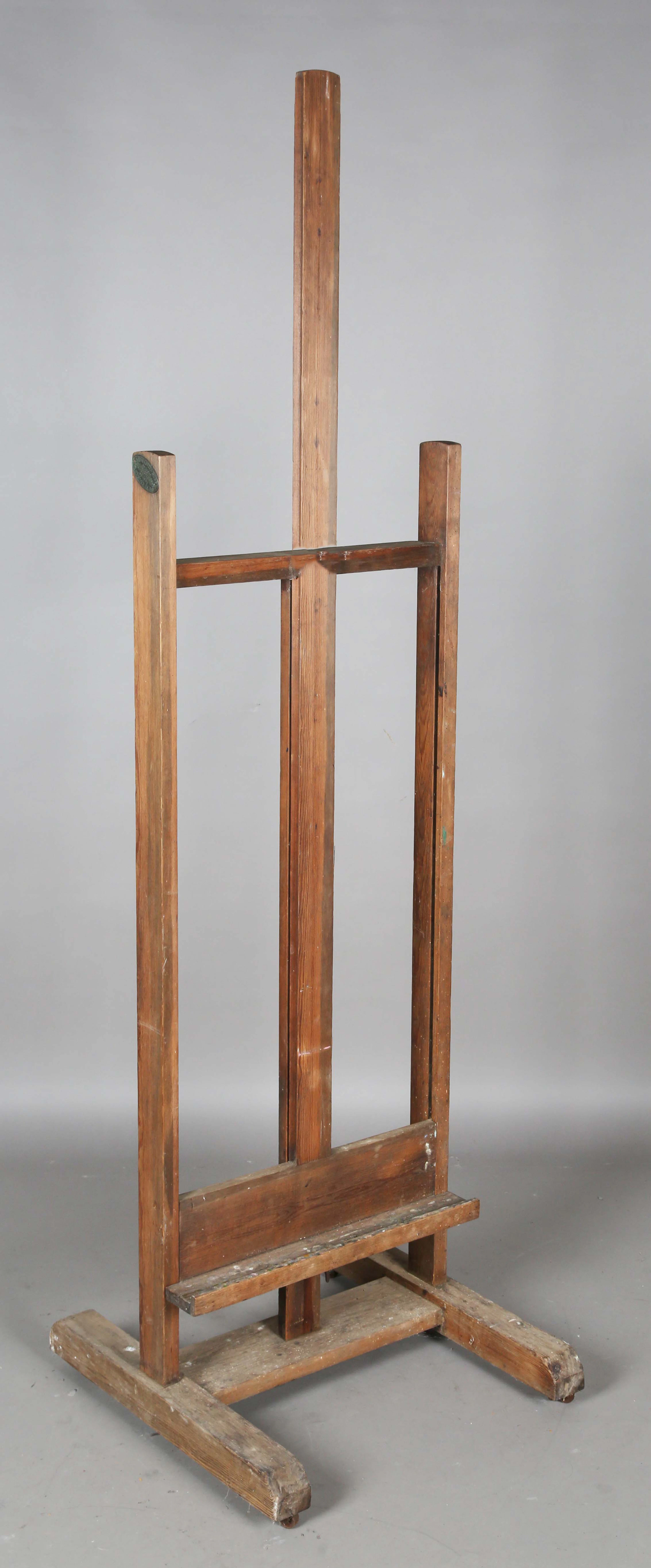 An early 20th century pine framed artist's easel, bearing maker's