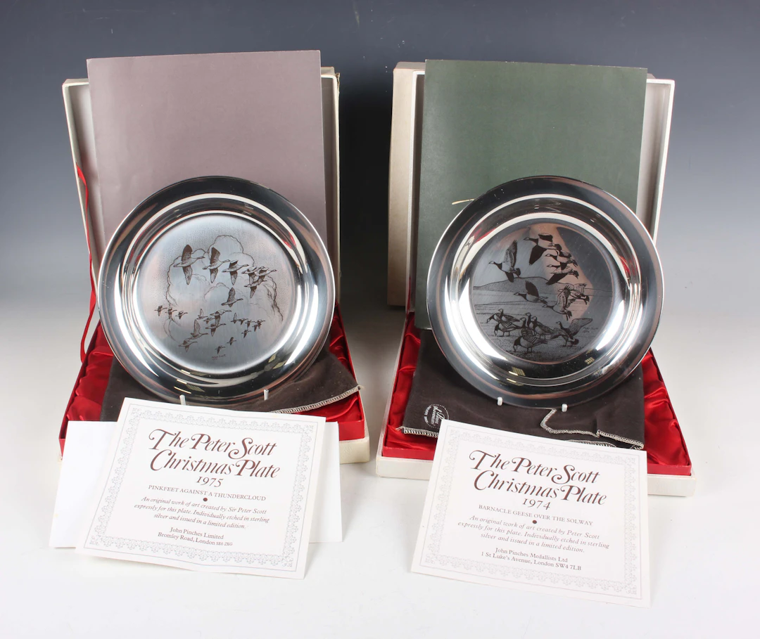 A set of four Elizabeth II silver Peter Scott Christmas plates, each
