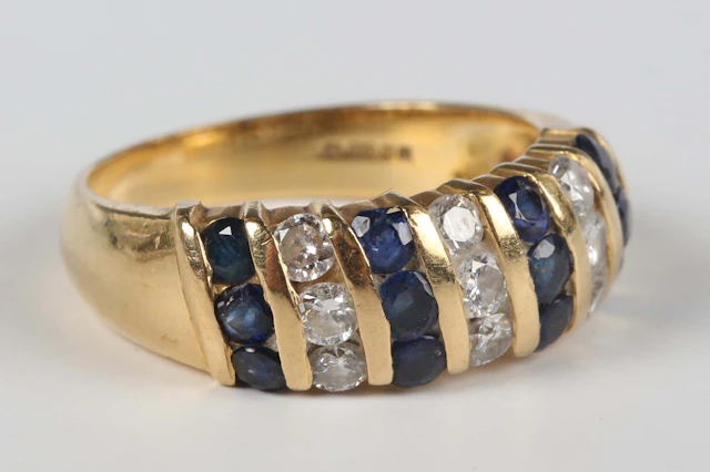 An 18ct gold, sapphire and diamond ring in a slanting design, mounted