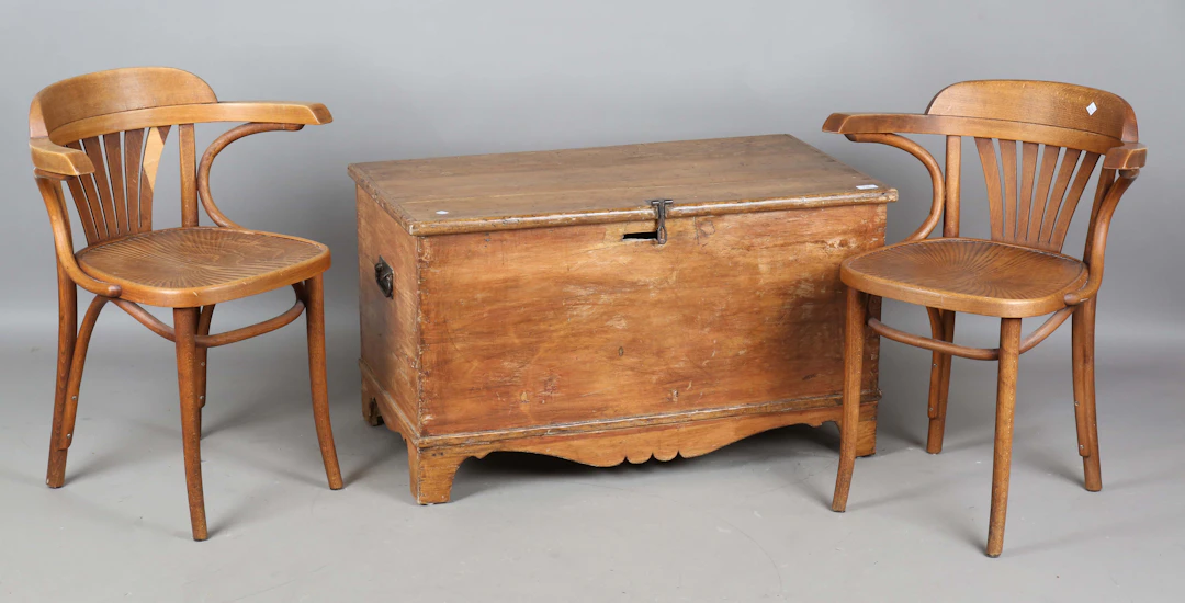 A pair of early 20th century bentwood elbow chairs with embossed plywood
