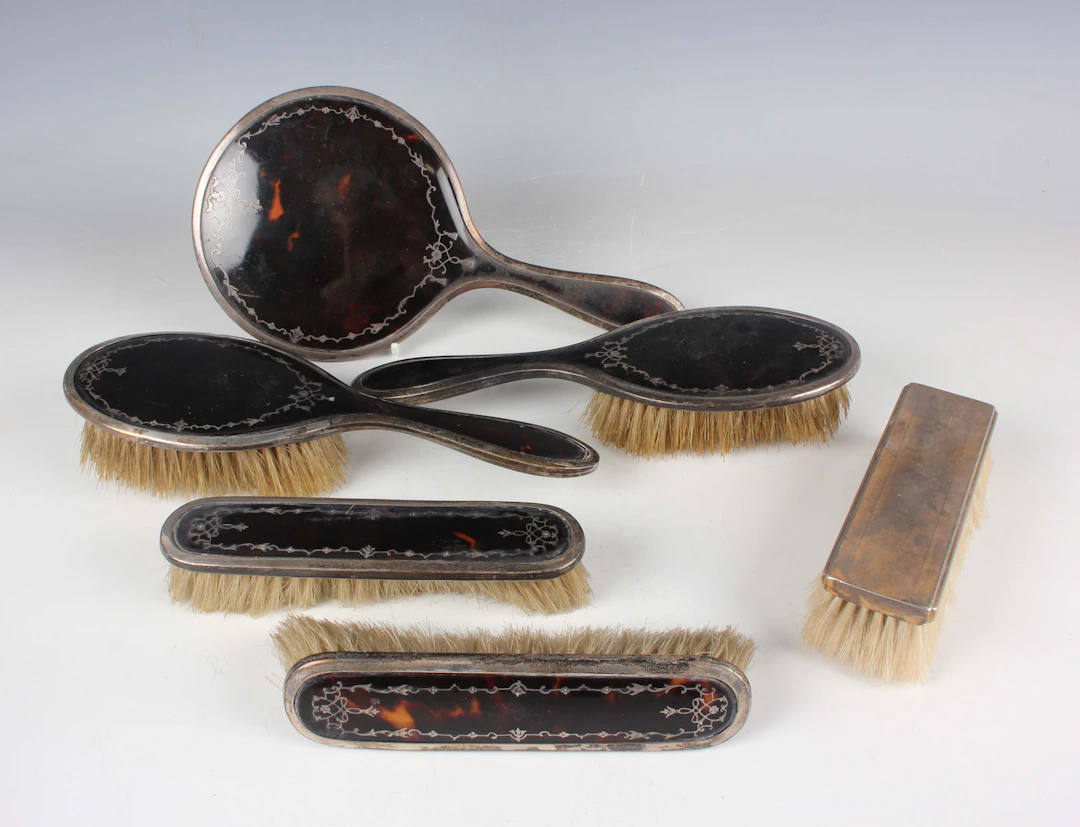 A George V silver and tortoiseshell five-piece dressing table set